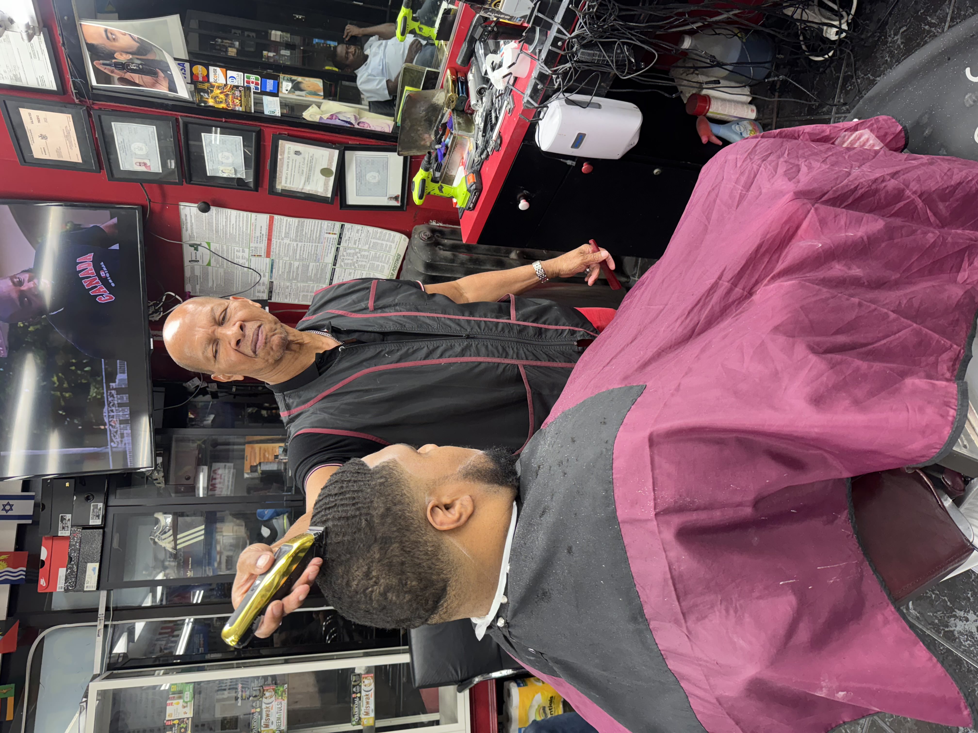 Barber Linton lining up a client at World Barbershop